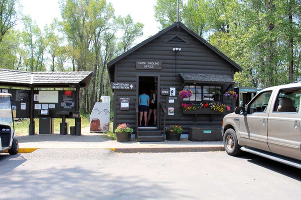 Gros Ventre campground kiosk with information board and visitors checking in.