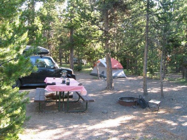 Campsite with tent and picnic table.