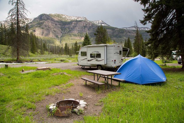 Tent and camper at campsite.