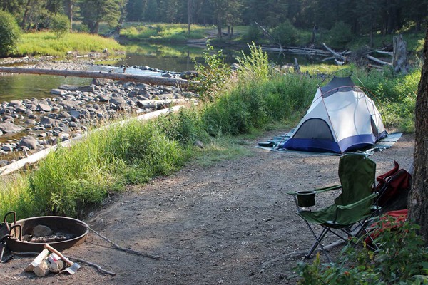 Tent and camp chair at campsite